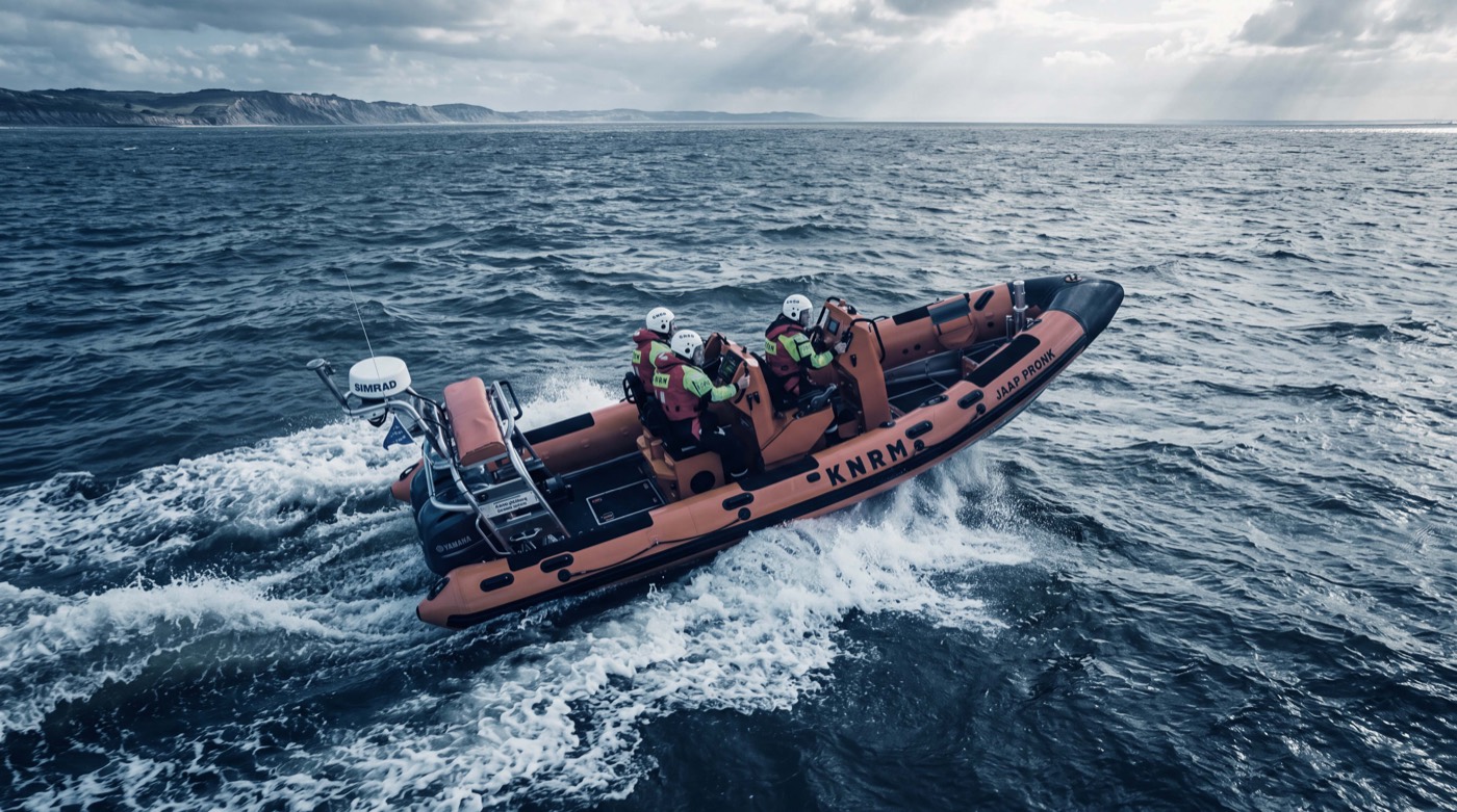 KNRM lifeboat crew underway at sea in choppy conditions off the coast